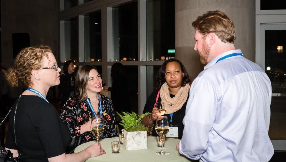 AMMC attendees networking at reception in Seattle.
